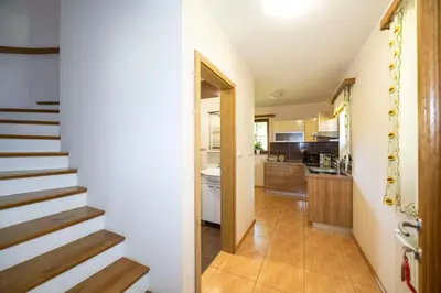 a hallway with a staircase leading to a kitchen at Tourist Farm Rajšp in Benedikt v Slovenskih Goricah