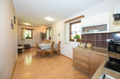a kitchen and dining room with a table and chairs at Tourist Farm Rajšp in Benedikt v Slovenskih Goricah