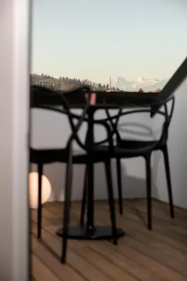a table and a chair in a room at La Villa Ljubljana in Ljubljana