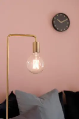a glass lamp with a clock on a wall at La Villa Ljubljana in Ljubljana