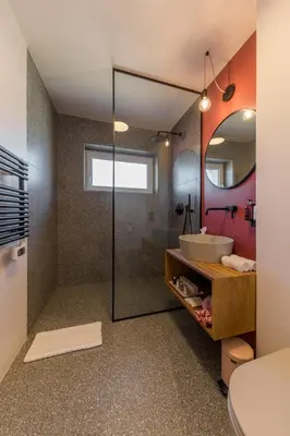 a bathroom with a glass shower and a sink at La Villa Ljubljana in Ljubljana