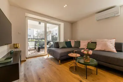 a living room with a couch and a table at La Villa Ljubljana in Ljubljana