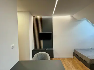 a bedroom with a bed and a table and chairs at Kamr’ca in Ljubljana
