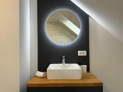 a bathroom with a sink and a mirror at Kamr’ca in Ljubljana