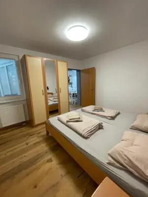 a bedroom with two beds and a mirror at Apartma Ajda in Moravske Toplice