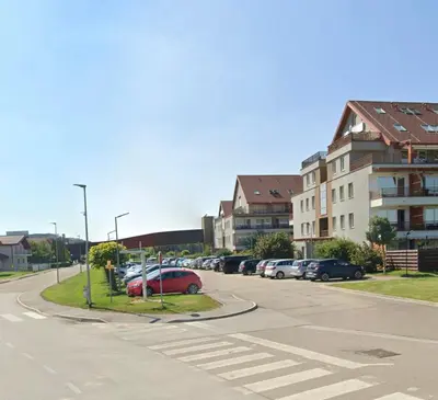 a street with cars parked in a parking lot at Apartma Ajda in Moravske Toplice