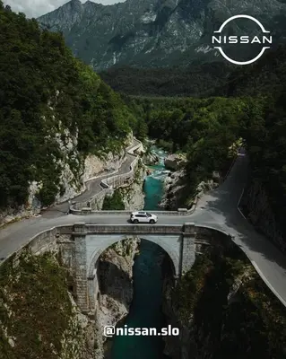 a car driving on a bridge over a river at Apartment Aria in Kobarid