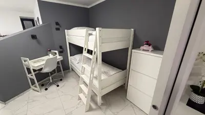 a room with two bunk beds and a desk at Apartment Aria in Kobarid