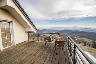 a balcony with a table and chairs and a view at Villa Zupan with Hot Tub in Škocjan