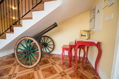 a room with a wagon wheel and a table at Villa Zupan with Hot Tub in Škocjan