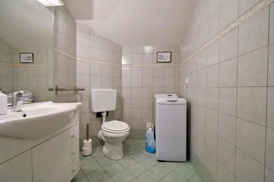 a bathroom with a toilet and a sink at Hostel X Point in Kobarid