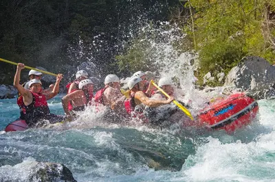 a group of people on a raft in a river at Hostel X Point in Kobarid