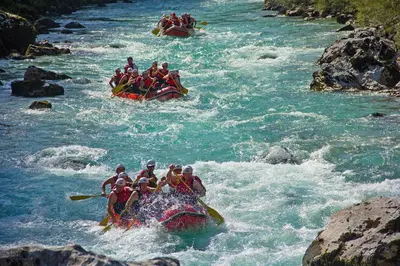a group of people in rafts in a river at Hostel X Point in Kobarid