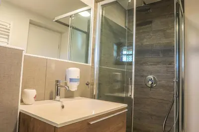 a bathroom with a sink and a shower at Apartmaji Tina in Zgornje Gorje