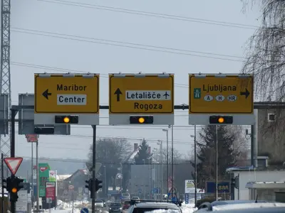 a street with traffic signs on a road with cars at Motel Divjak in Spodnje Hoče