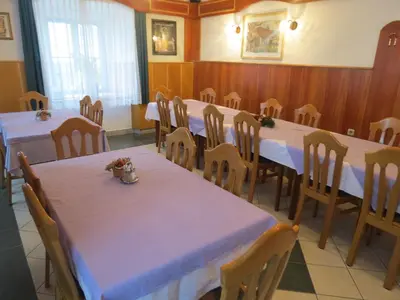 a dining room with tables and chairs with white table cloth at Motel Divjak in Spodnje Hoče