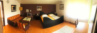 a living room with a bed and a couch at Guesthouse Marko in Bled