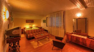 a living room with a couch and a television at Guesthouse Marko in Bled