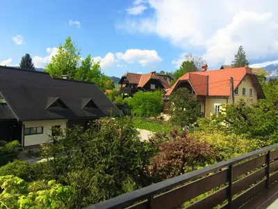 a group of houses with trees and a fence at Guesthouse Marko in Bled