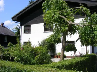 a white house with a tree in front of it at Guesthouse Marko in Bled