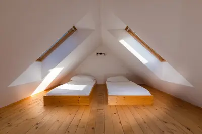 two beds in a attic bedroom with skylights at Koritnica Apartments in Bovec
