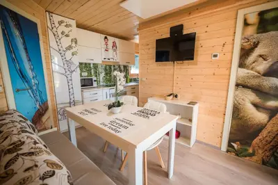 a small kitchen with a white table in a room at Glamping Krone Kolpa Heaven in Adlešiči