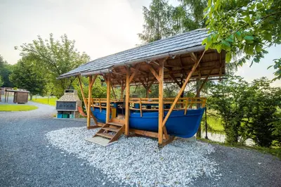 a small blue boat with a roof on top at Glamping Krone Kolpa Heaven in Adlešiči