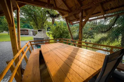 a wooden deck with a table and chairs on a porch at Glamping Krone Kolpa Heaven in Adlešiči