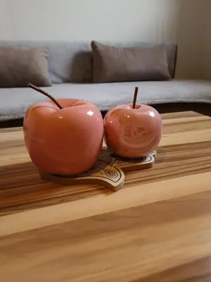 two red apples sitting on top of a table at Apartments Karin in Bled