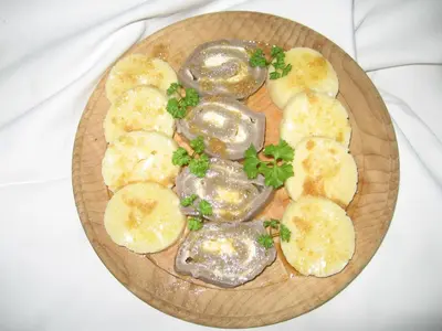 a plate of food with oysters and onions on it at Tourist Farm Pri Martinovih in Krška Vas