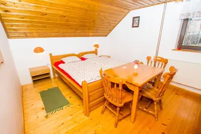 a bedroom with a bed and a table and chairs at Tourist Farm Pri Martinovih in Krška Vas