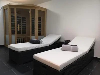 two twin beds in a room with white sheets at Apartma Lucijana in Mojstrana