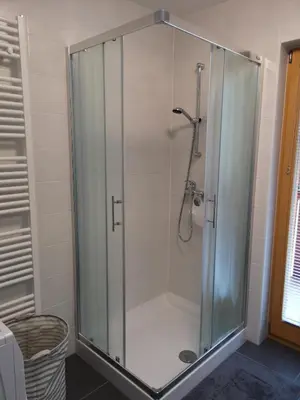 a shower with a glass enclosure in a bathroom at Apartma Lucijana in Mojstrana