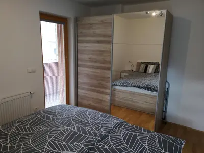 a bedroom with a large mirror and a bed at Apartma Lucijana in Mojstrana