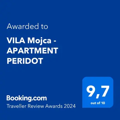 a blue sign with the text awarded to vla mica apartmentarantarantractor at Villa Mojca - Apartment Peridot in the Center with Private Indoor Parking in Kranjska Gora