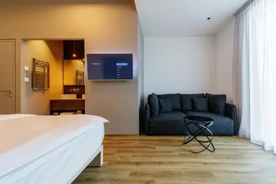 a hotel room with a couch and a bed at WUD hotel in Ljubljana