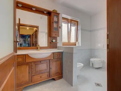 a bathroom with a sink and a toilet at Family Apartment Rihter in Črni Kal