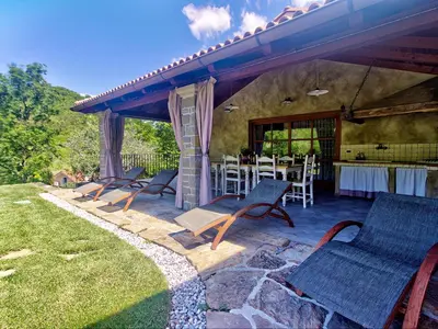 a group of chairs and a table on a patio at Family Apartment Rihter in Črni Kal