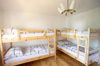 a room with four bunk beds in a room at Hostel LakeBled in Bled