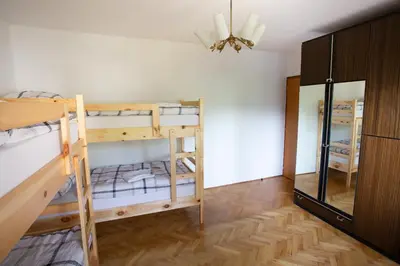 a room with two bunk beds and a mirror at Hostel LakeBled in Bled
