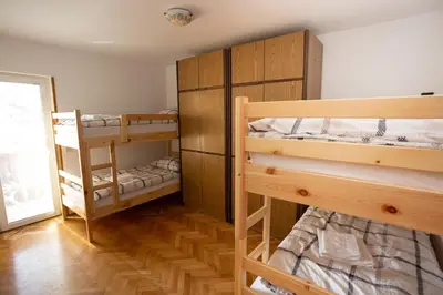 a room with two bunk beds and a window at Hostel LakeBled in Bled