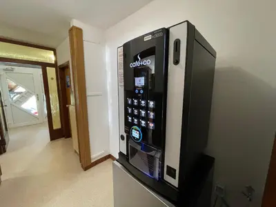 a black vending machine is in a room at Hostel LakeBled in Bled