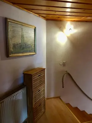 a room with a staircase with a picture on the wall at Stay Apartments Bled in Bled