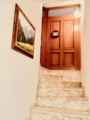 a door with a painting on the wall next to stairs at Stay Apartments Bled in Bled