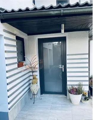 a front door of a house with a vase next to it at Stay Apartments Bled in Bled