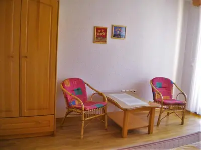 a room with two chairs and a table and a table at APARTMA PR TAVČARJU in Zgornje Gorje