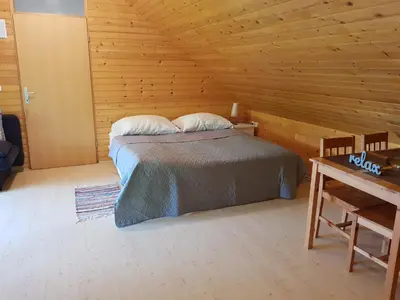 a bedroom with a bed in a wooden cabin at Apartma Take It Easy in Bled
