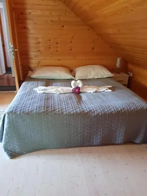 a girl laying on a bed with a teddy bear at Apartma Take It Easy in Bled