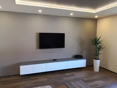 a living room with a tv on a wall at Bonito apartment in Postojna
