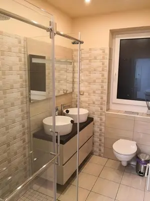 a bathroom with two sinks and a toilet at Bonito apartment in Postojna